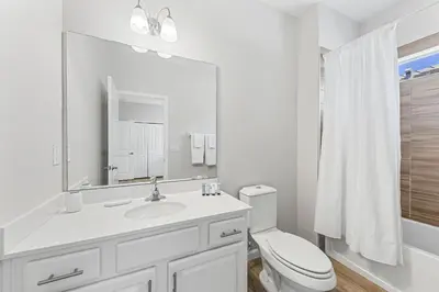 a white bathroom with a sink and a toilet at 2605 Yountville Ave in Kissimmee