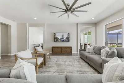 a living room with a couch and a ceiling fan at 2605 Yountville Ave in Kissimmee