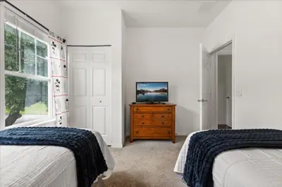 a bedroom with two beds and a television on a dresser at 4 Bedrooms 3 Bathrooms Lucaya Village 23-108 in Kissimmee