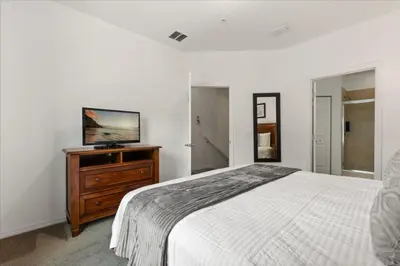 a bedroom with a bed and a television on a dresser at 4 Bedrooms 3 Bathrooms Lucaya Village 23-108 in Kissimmee