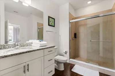 a bathroom with a shower and a toilet and a sink at 4 Bedrooms 3 Bathrooms Lucaya Village 23-108 in Kissimmee