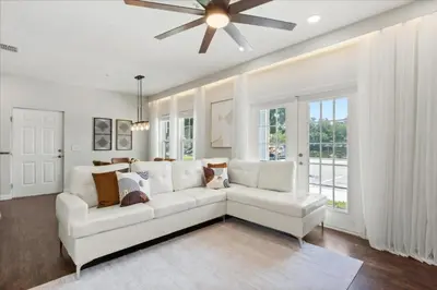 a living room with a white couch and a ceiling fan at 4 Bedrooms 3 Bathrooms Lucaya Village 23-108 in Kissimmee