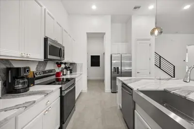 a large white kitchen with white cabinets and appliances at 15 Bedrooms 16 Bathrooms Sonoma 4151 Sb in Kissimmee
