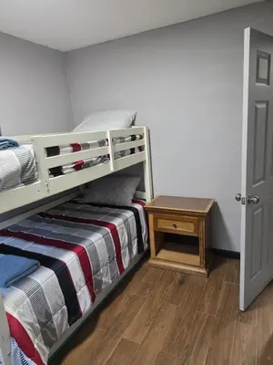 a small bedroom with a bunk bed and a table at Epic Universal park neigbour 1500 feet in Orlando