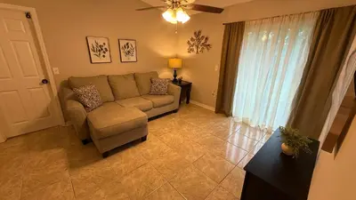 a living room with a couch and a window at K11 Private Room with Smart TV Near Everything in Orlando