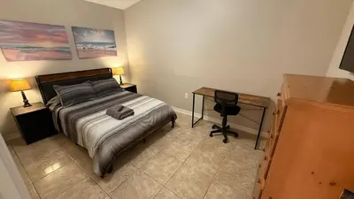 a bedroom with a bed and a desk in it at L12 Private Room with Smart TV Near Everything in Orlando