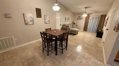 a living room with a table and a couch at L12 Private Room with Smart TV Near Everything in Orlando