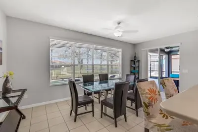 a dining room with a table and chairs at 6 Bedrooms - 5,5 Bathrooms - Bella Vida 4529Ss in Kissimmee