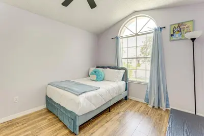 a bedroom with a bed and a window at 6 Mi to Disney World Lake-View Retreat with Pool! in Kissimmee
