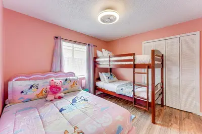 a bedroom with two bunk beds and a teddy bear at 6 Mi to Disney World Lake-View Retreat with Pool! in Kissimmee