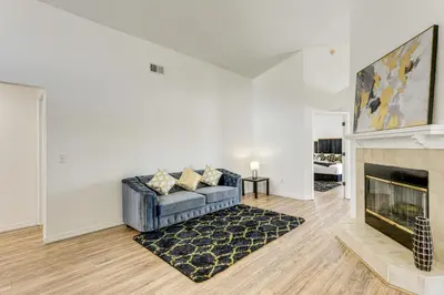 a living room with a couch and a fireplace at 6 Mi to Disney World Lake-View Retreat with Pool! in Kissimmee