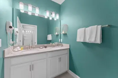 a bathroom with a sink and a mirror at 4824 Resort Pool House Disney Universal Orlando in Kissimmee