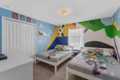 a bedroom with two beds and a rainbow wall at 4824 Resort Pool House Disney Universal Orlando in Kissimmee