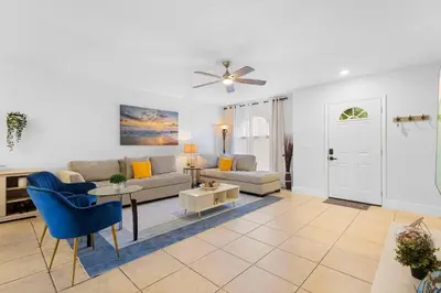 a living room with a couch and a table at Magic & Comfort in the Palms!Near Disney-Universal in Kissimmee