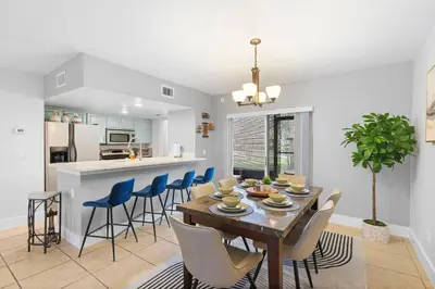 a dining room and kitchen with a table and chairs at Magic & Comfort in the Palms!Near Disney-Universal in Kissimmee