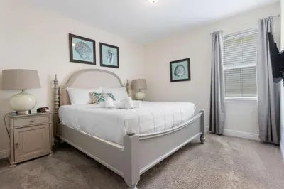 a bedroom with a white bed and a window at 361 Pendant ct in Orlando