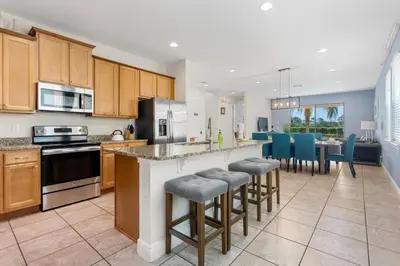 a kitchen with a large island in a kitchen with blue chairs at 361 Pendant ct in Orlando