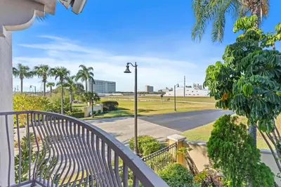 a balcony with a street light and palm trees at 8036 Spacious Fresh 3BR3.5BA at Vista Cay 133 in Orlando