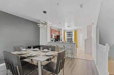 a dining room and kitchen with a table and chairs at 8036 Spacious Fresh 3BR3.5BA at Vista Cay 133 in Orlando