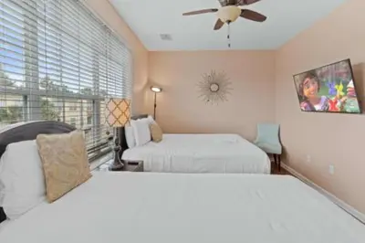 a bedroom with two beds and a ceiling fan at 3-Story sanctuary Condo in the heart of Orlando85 in Orlando