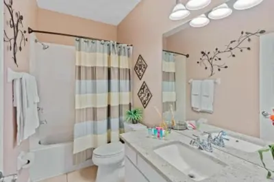 a bathroom with a sink and a toilet and a tub at 3-Story sanctuary Condo in the heart of Orlando85 in Orlando