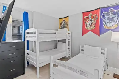 a bedroom with two bunk beds and a desk at 2701 Enclave Condo near Univesal-Lakeview in Orlando
