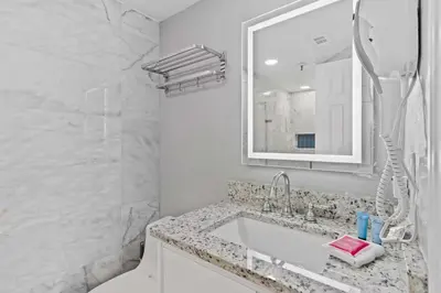 a white bathroom with a sink and a mirror at 2701 Enclave Condo near Univesal-Lakeview in Orlando