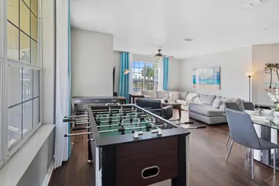 a living room with a foosball table in the middle at 5049 Ultimate Orlando retreat at Vista Cay 203 in Orlando