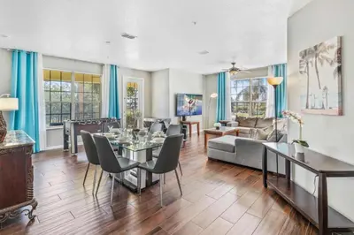 a living room with a table and chairs at 5049 Ultimate Orlando retreat at Vista Cay 203 in Orlando