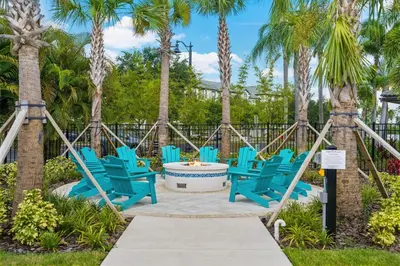 a group of blue chairs and palm trees at 5049 Ultimate Orlando retreat at Vista Cay 203 in Orlando