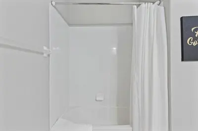 a shower with a white shower curtain in a bathroom at 5048 Light and Airy Resort 4BD Apartment 407 in Orlando