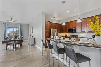 a kitchen and dining room with a table and chairs at 5048 Light and Airy Resort 4BD Apartment 407 in Orlando