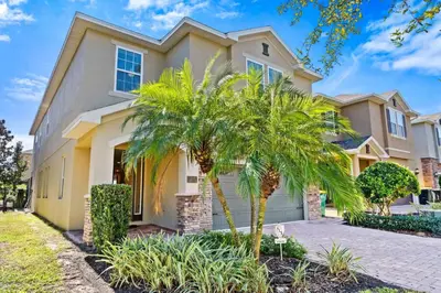 a house with palm trees in front of it at 500 Luxurious 8BR Villa with Private PoolSpa in Orlando