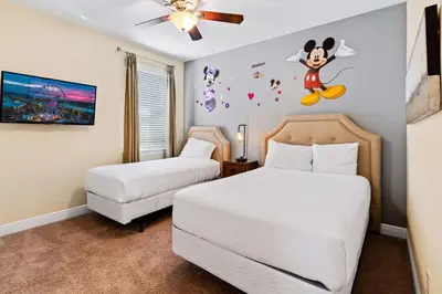 a bedroom with two beds and a mouse on the wall at 500 Luxurious 8BR Villa with Private PoolSpa in Orlando