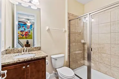 a bathroom with a toilet sink and a shower at 500 Luxurious 8BR Villa with Private PoolSpa in Orlando