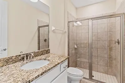 a bathroom with a shower and a sink and a toilet at 500 Luxurious 8BR Villa with Private PoolSpa in Orlando