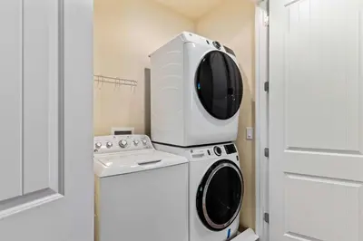 a microwave sitting on top of a washing machine at 500 Luxurious 8BR Villa with Private PoolSpa in Orlando
