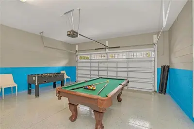 a room with a pool table and a garage at 500 Luxurious 8BR Villa with Private PoolSpa in Orlando