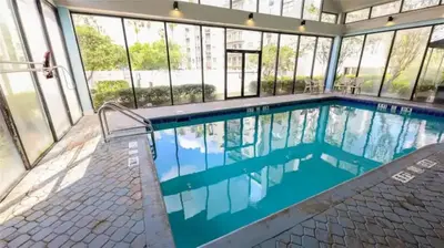 a swimming pool in a building with windows at 3704 Relax Unwind 2-BD 2-BA Resort Condo in Orlando