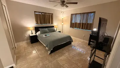 a bedroom with a bed and a flat screen tv at M13 Large Master Room with Private Bathroom & Smart TV in Orlando