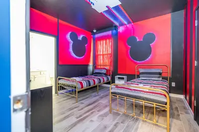 two beds in a room with pink and black walls at Stunning Masterpiece 15 ensuites in Kissimmee