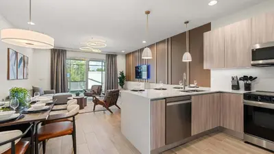 a kitchen and living room with a table and chairs at Upstay Pristine 3BR Home with Private Pool & BBQ in Orlando