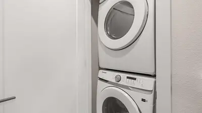 a washing machine and a dryer in a room at Upstay Pristine 3BR Home with Private Pool & BBQ in Orlando