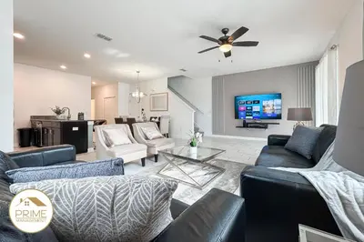 a living room with a couch and a tv at New Themed Rooms5BR Near AttractionsResort in Kissimmee