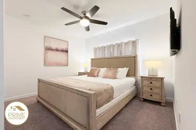 a bedroom with a bed and a ceiling fan at New Themed Rooms5BR Near AttractionsResort in Kissimmee