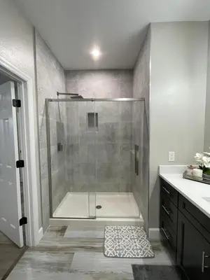 a shower with a glass door in a bathroom at Gated 3BR 3BA Townhome Near Disney w Pool and Gym in Orlando