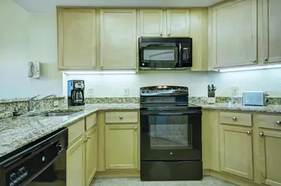a kitchen with a stove and a microwave at Wyndham Star Island Resort 1BR Apartment with Resort Access in Kissimmee