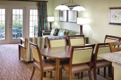 a living room with a table and chairs and a couch at Wyndham Star Island Resort 1BR Apartment with Resort Access in Kissimmee