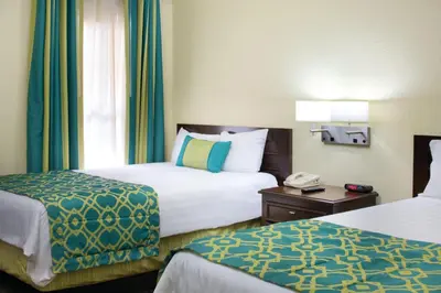 a hotel room with two beds and a phone at Wyndham Star Island Resort 1BR Apartment with Resort Access in Kissimmee