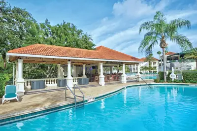 a swimming pool with a gazebo next to a house at Wyndham Star Island Resort 3BR Apartment with Resort Access in Kissimmee